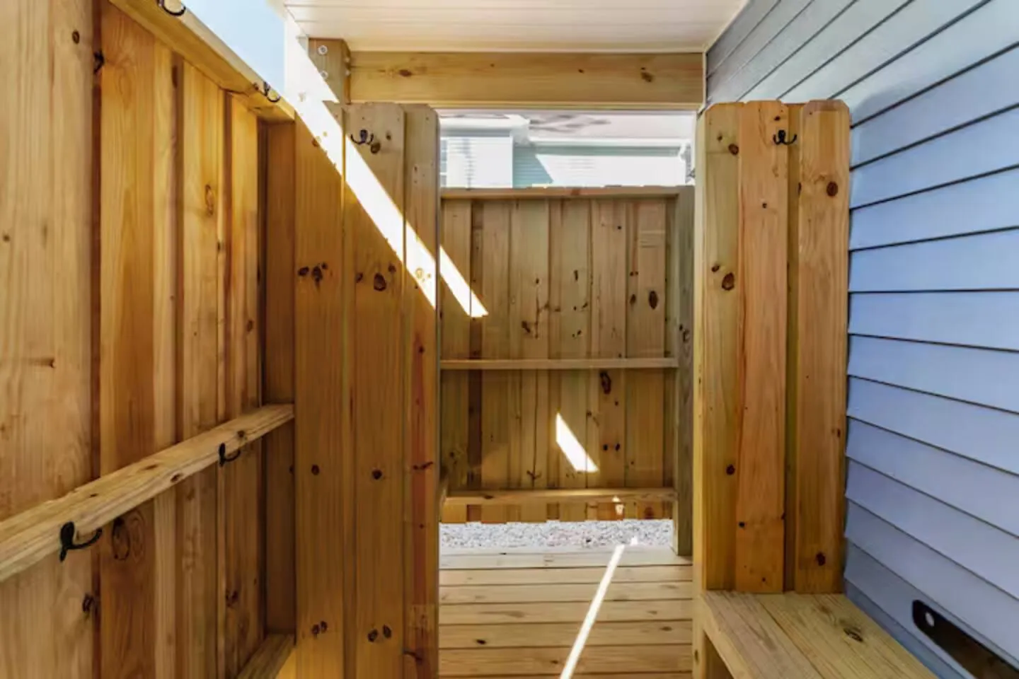 Cedar outdoor shower enclosure beside the house